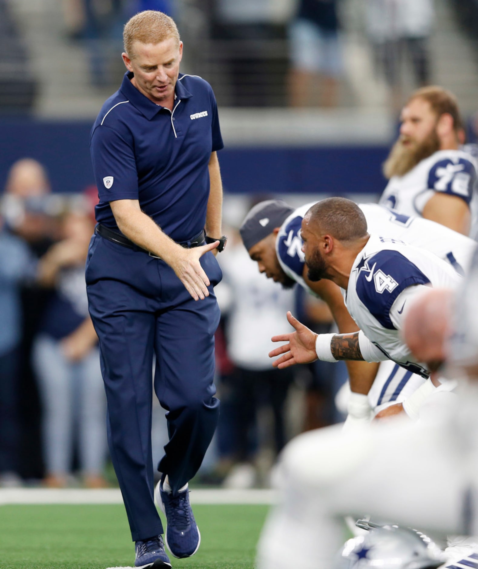 Dallas Cowboys head coach Jason Garrett greets Dallas Cowboys quarterback Dak Prescott (4)...