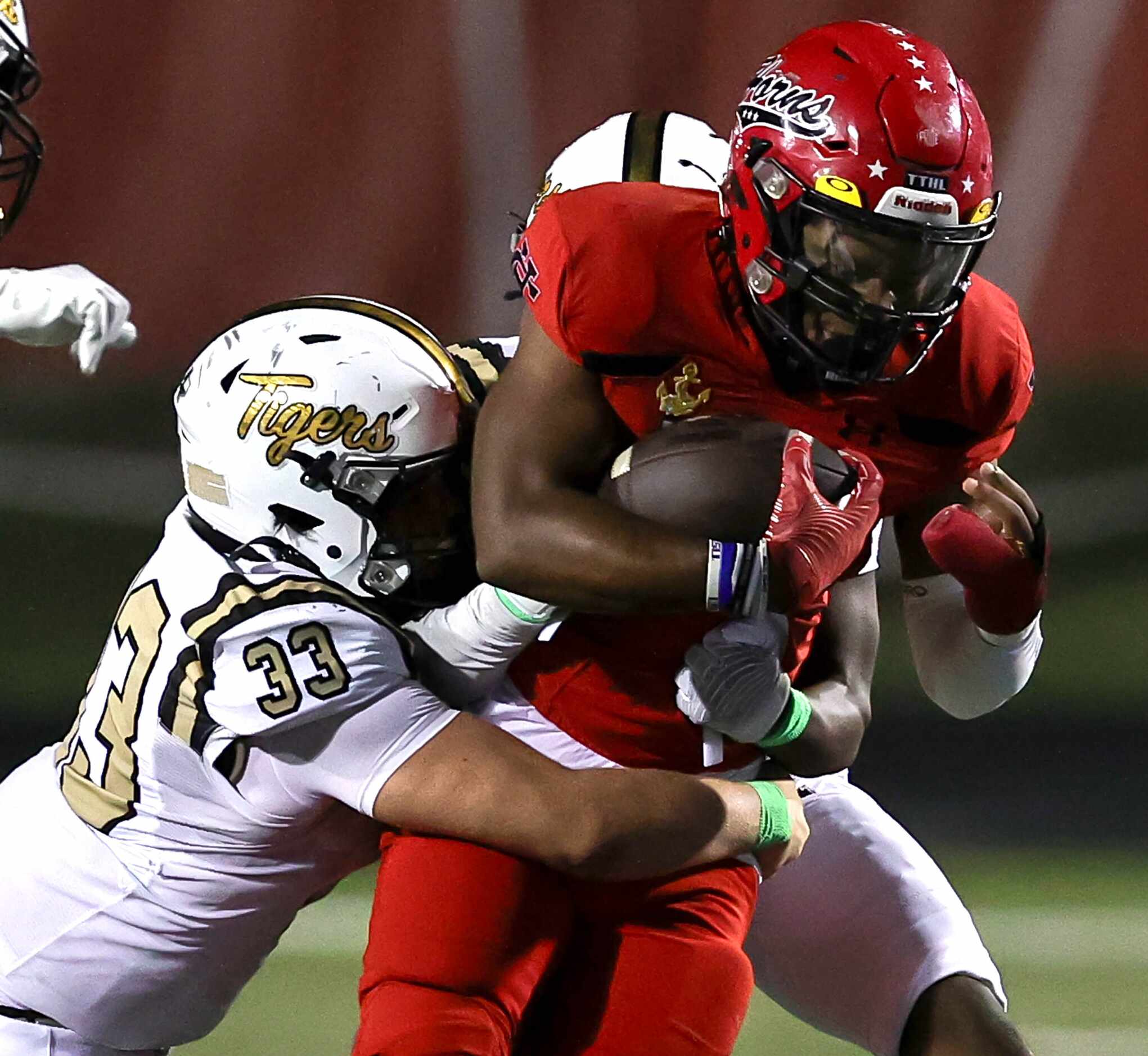 Cedar Hill running back Dayshun Reese-Williams (right) fights for some yardage against...