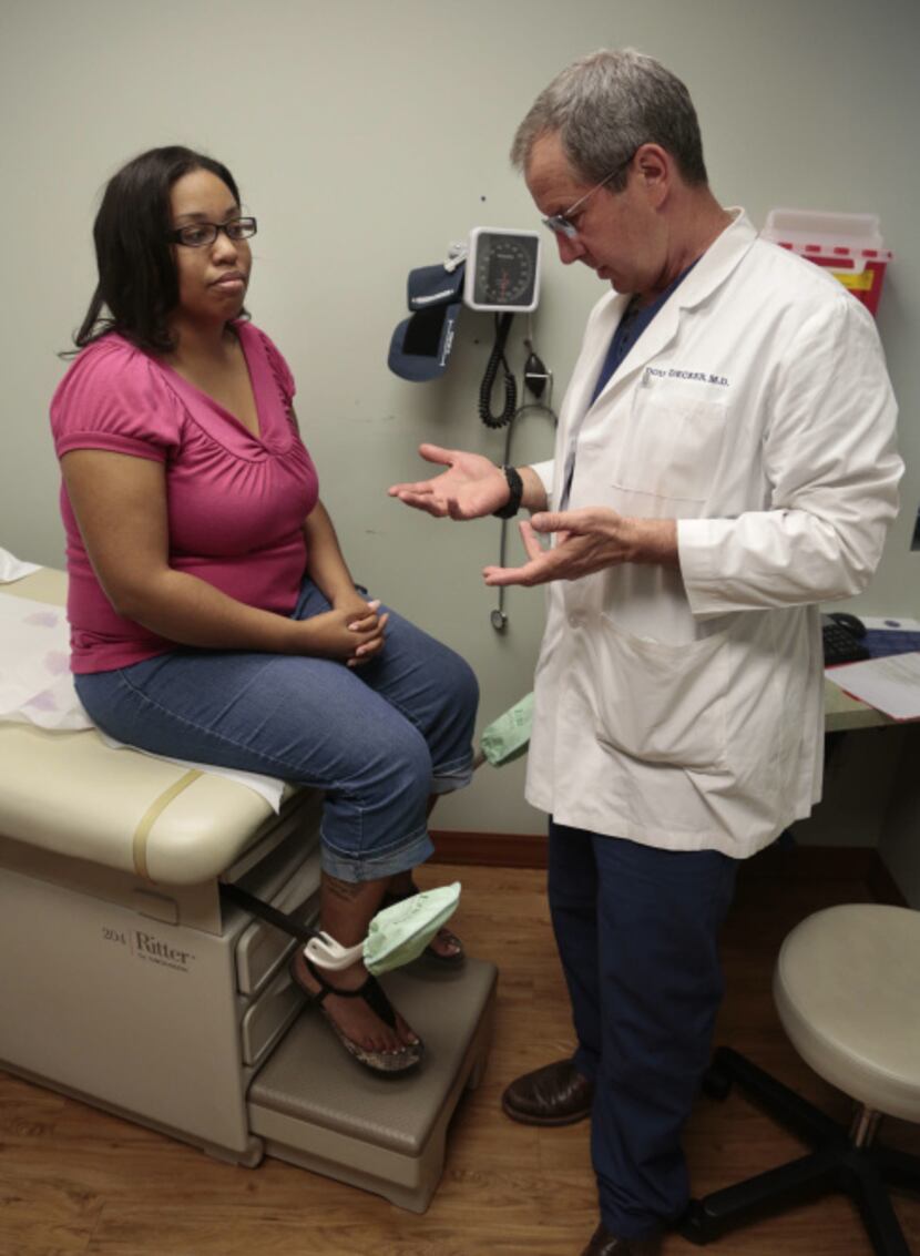 Dr. Douglas Decker prepares to perform acupuncture on Veronica Cooks , pregnant patient...