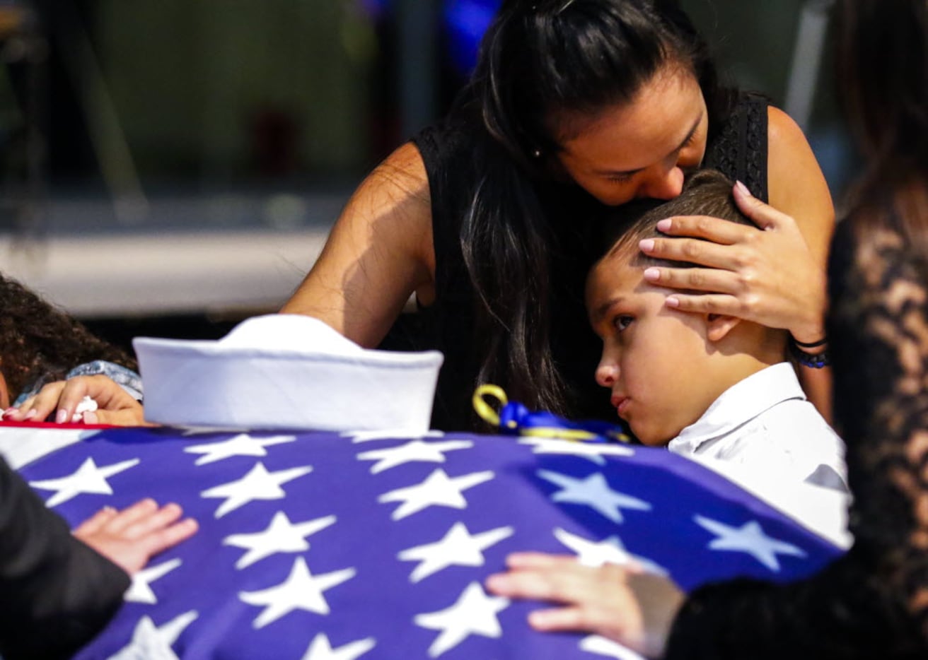 Kristy Villasenor, partner of Dallas police officer Patrick Zamarripa, shares a moment with...