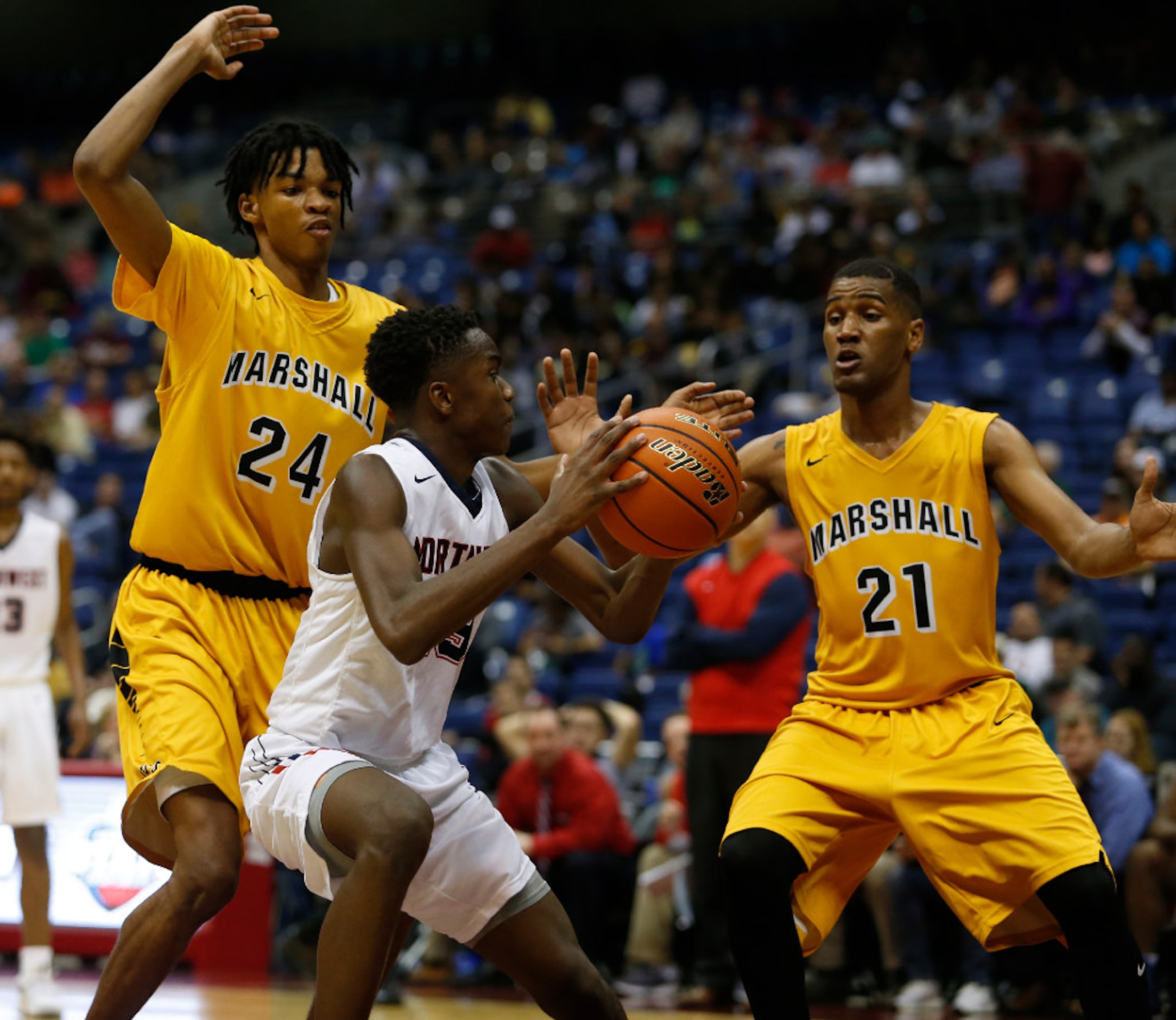 Justin Northwest's Jordan Keys (13) looks to score between Fort Bend Marshall's John Walker...