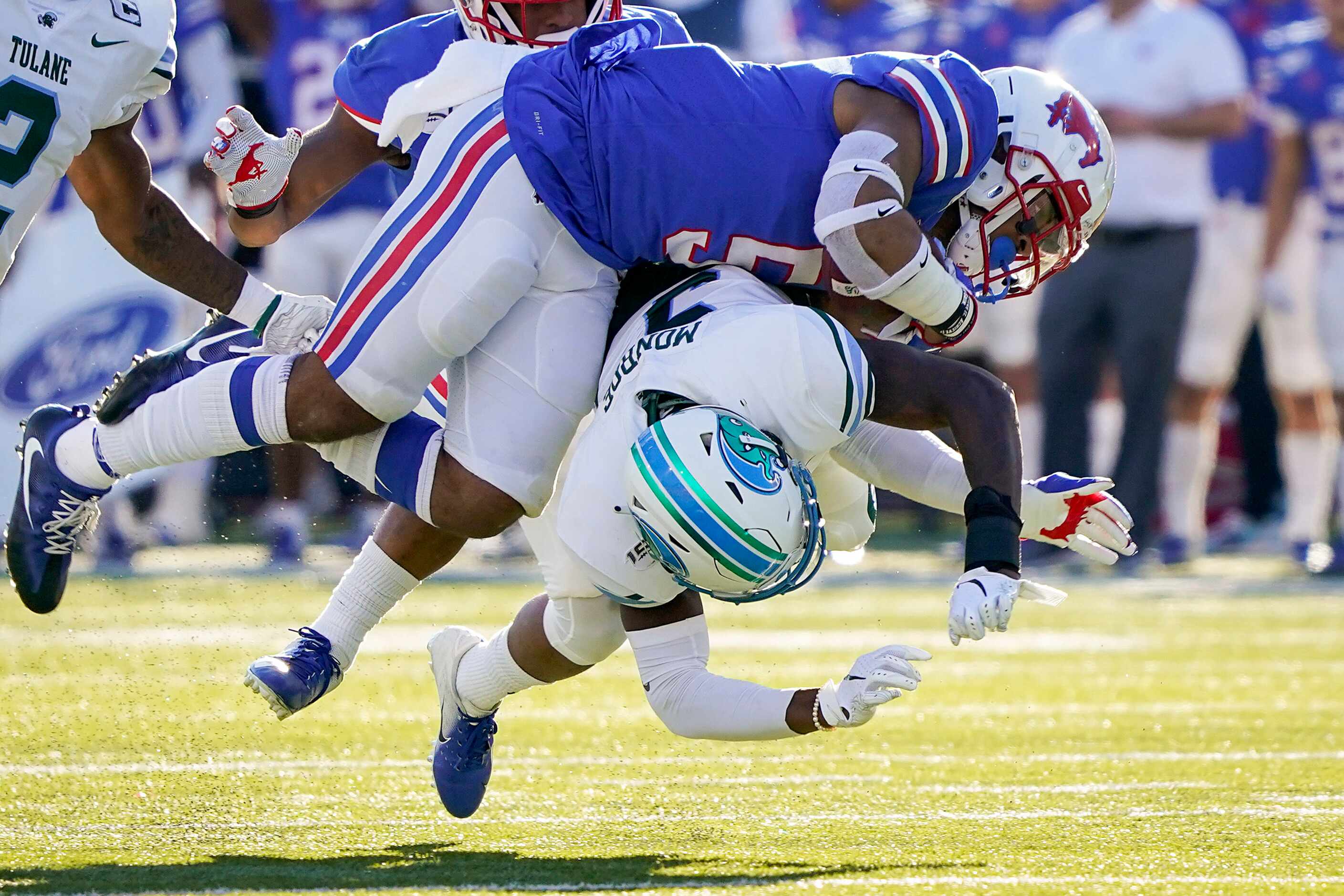 SMU running back Xavier Jones (5) is brought down by Tulane cornerback Jaylon Monroe (9) on...