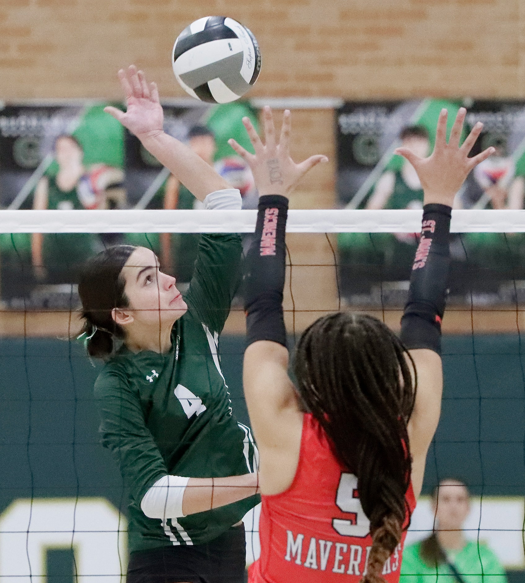 Hockaday setter Campbell Trubey hits the volleyball past St. John's Jacey Carroll (5) during...