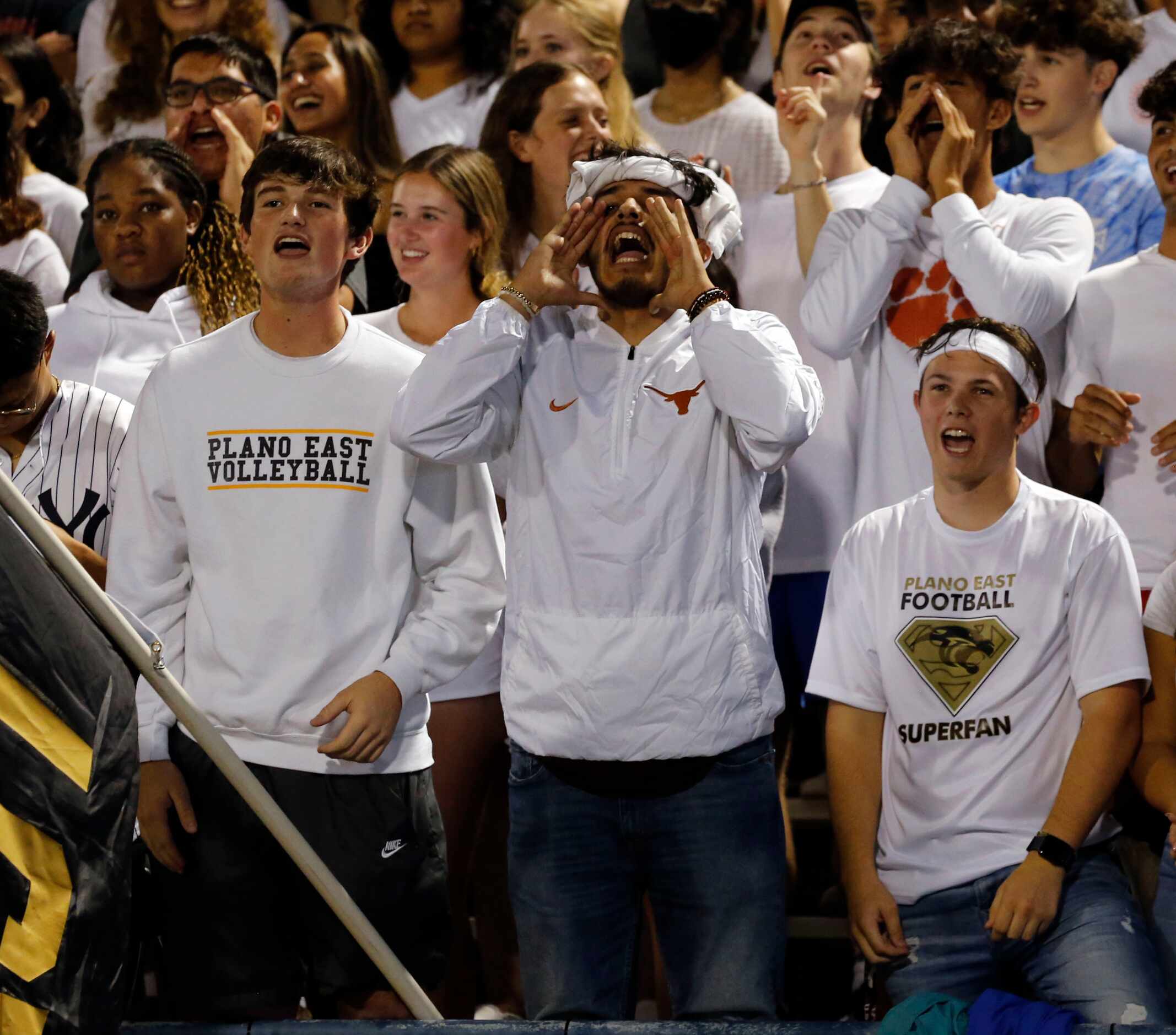 Plano East fans yell encouragement to the squad during the first half of a high school...