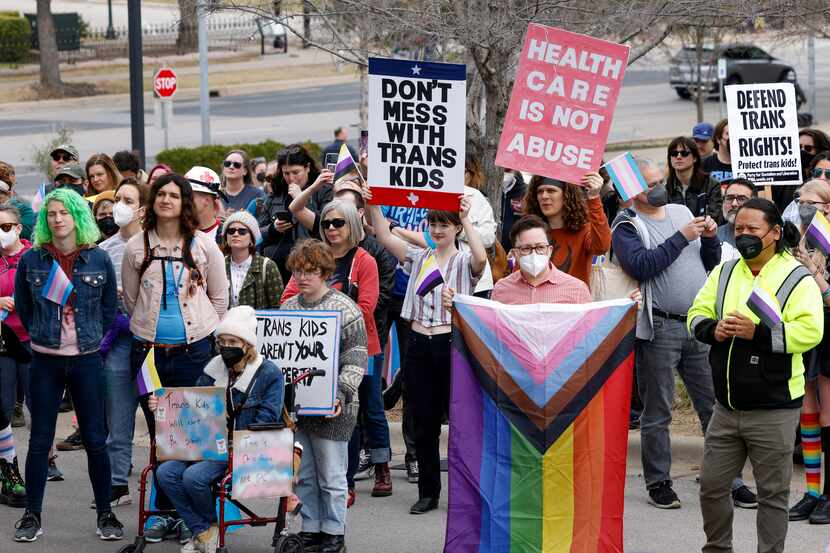 Familias de niños transgénero y otros manifestantes protestan afuera de la mansión del...