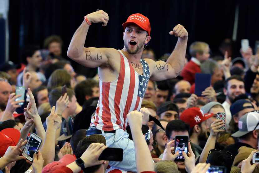 In this April 15, 2016, file photo, a Donald Trump supporter flexes his muscles with the...
