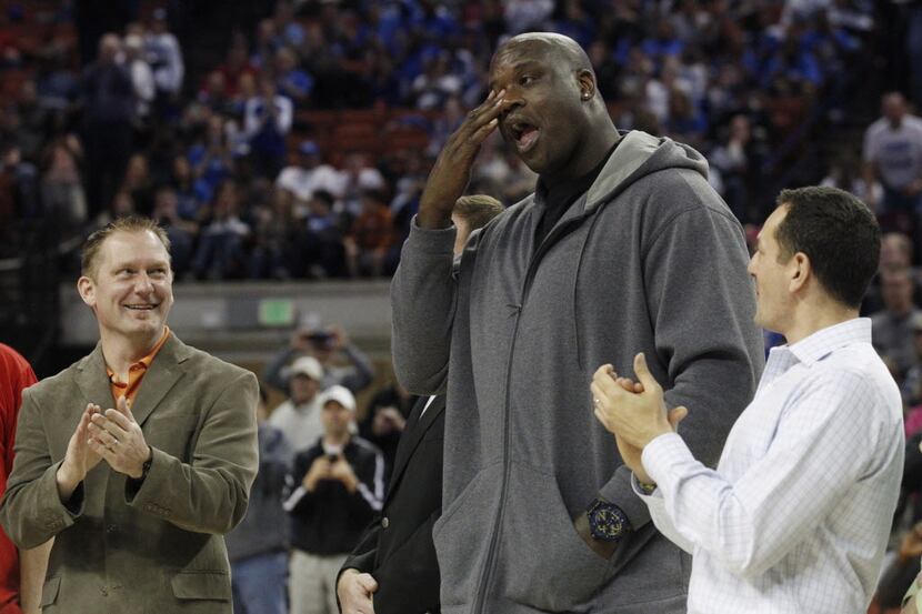 Shaquille 0'Neal wipes an imaginary tear for his eye as he and the 1989 San Antonio Cole...