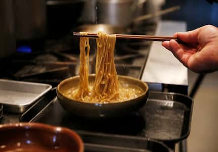 In this photo taken in April 2019, chef Justin Holt loosens noodles as he perfects the...