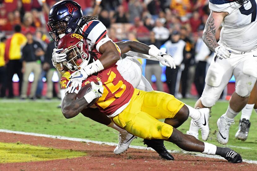 Southern California running back Ronald Jones II, below, dives in for a touchdown while...