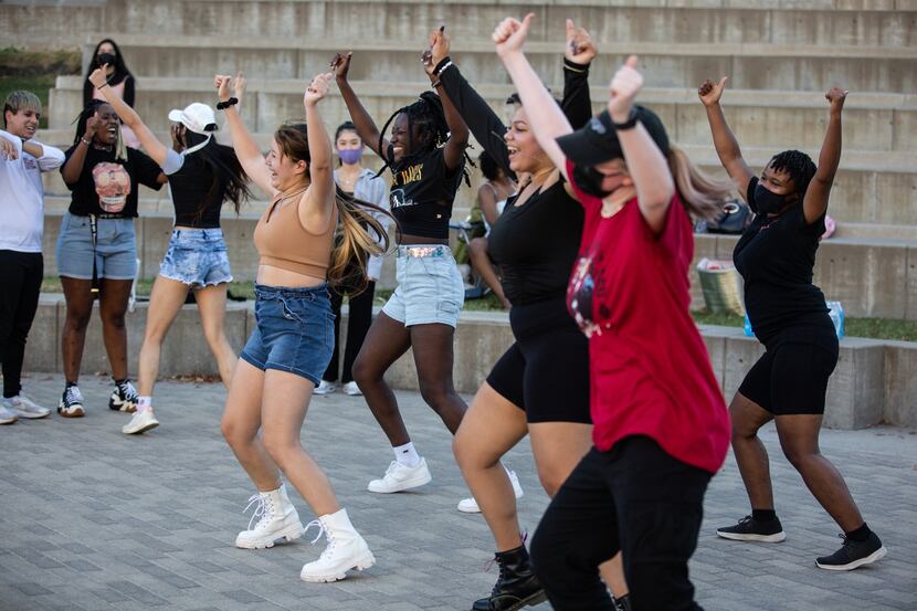 K-pop fans dance during a random dance play at a meetup organized by AEON, a Texas-based...