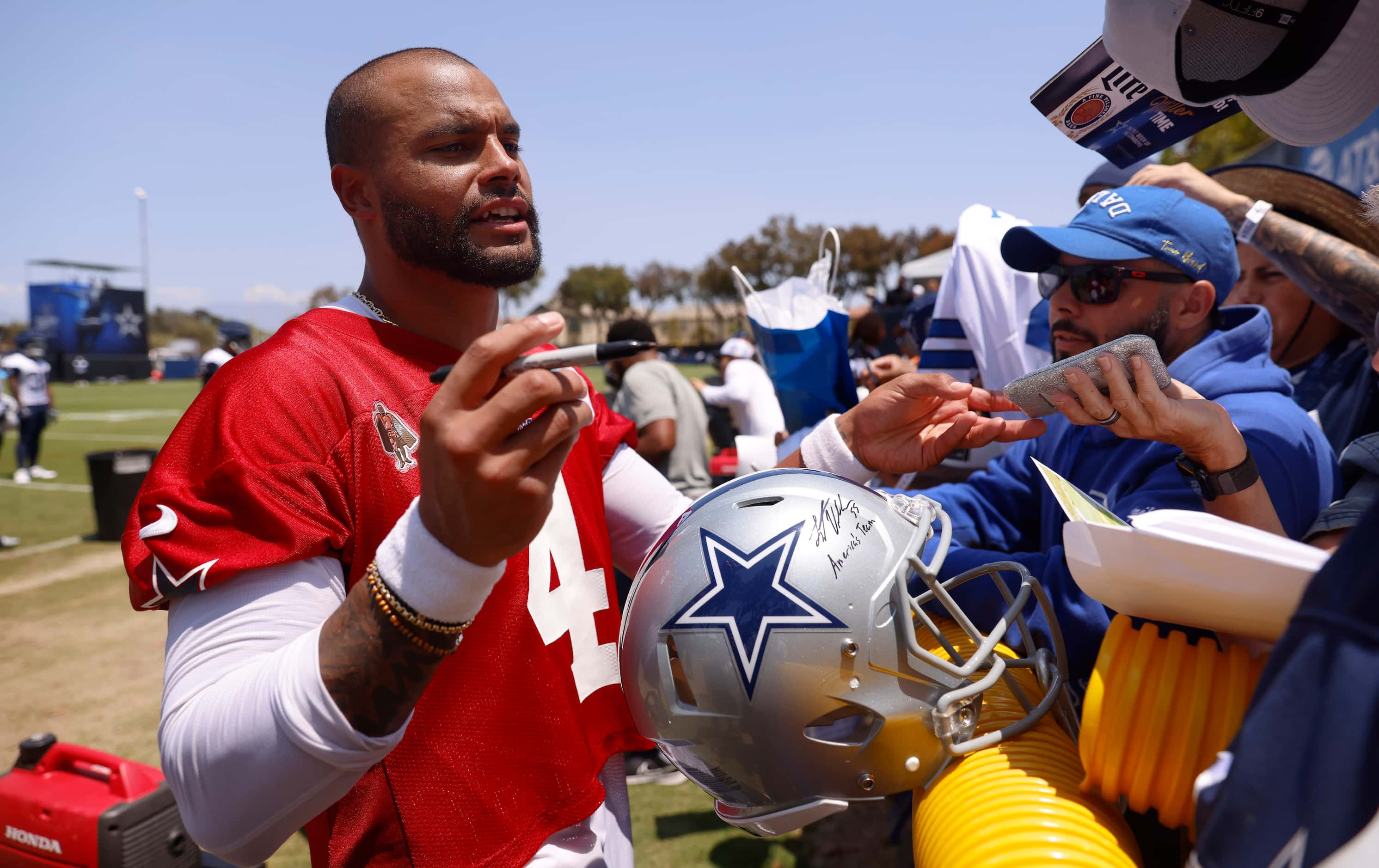 Dallas Cowboys quarterback Dak Prescott (4) signs autographs for fans following the  opening...