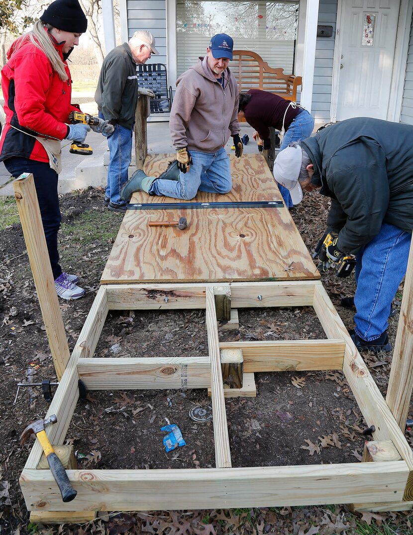 Project manager Kirk Saxon (center) of Melissa, Texas surveys the situation from his knees...