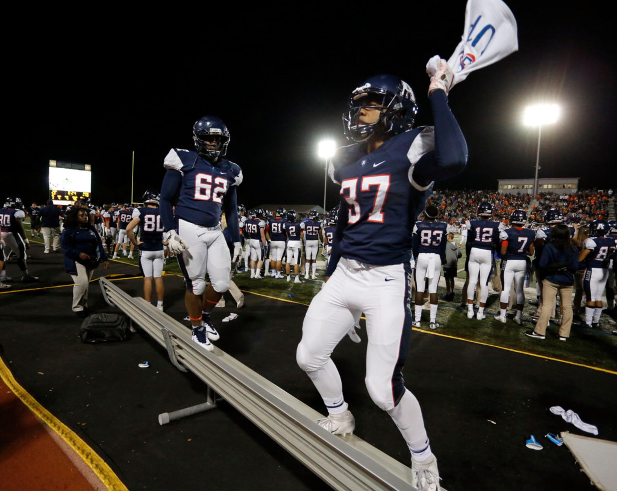 Allen players Kenatha Carter (62) and Kendall Hayes (37) celebrate on team's benches at the...