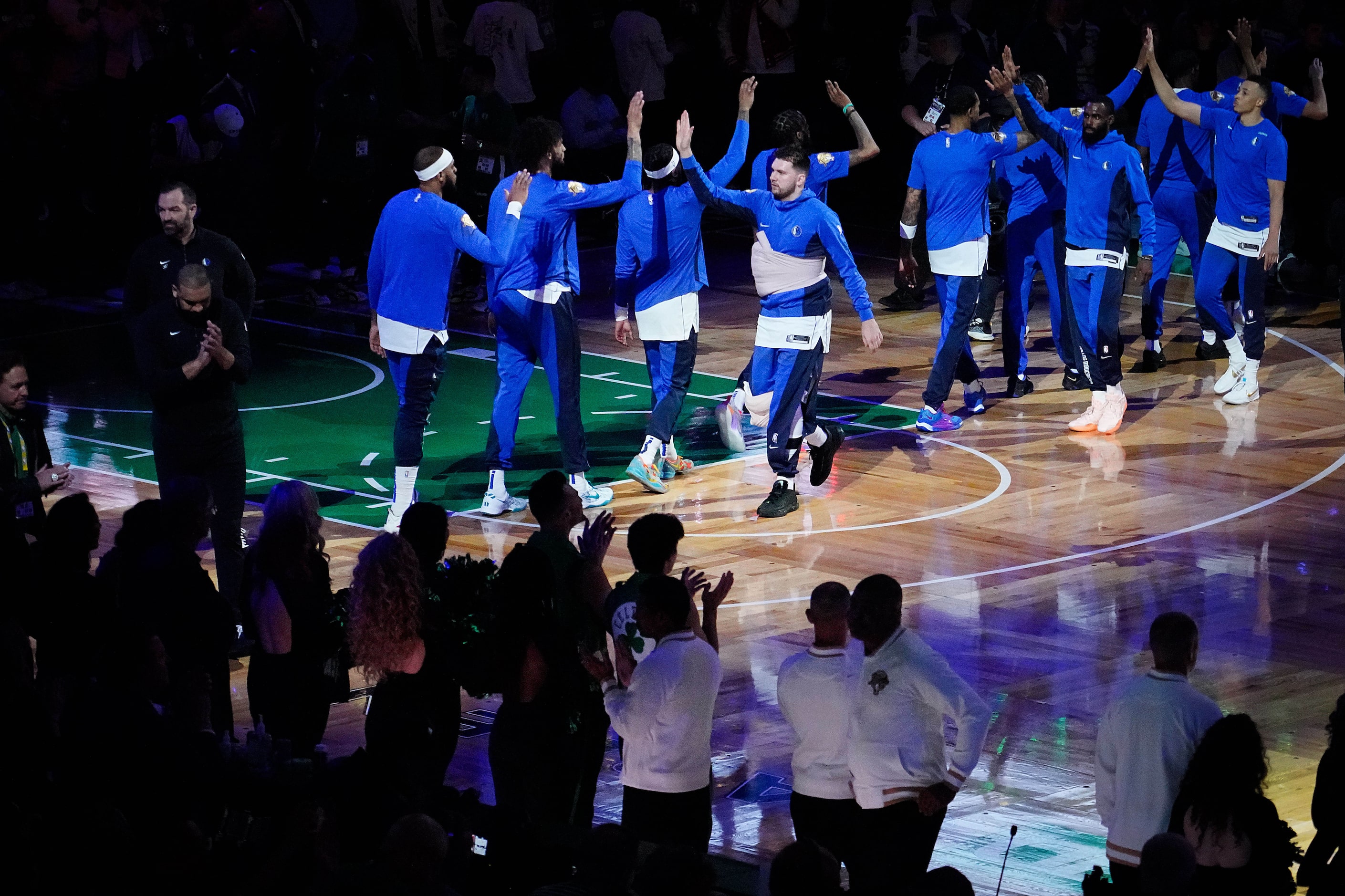 Dallas Mavericks guard Luka Doncic wears a wrap around his chest during pregame...