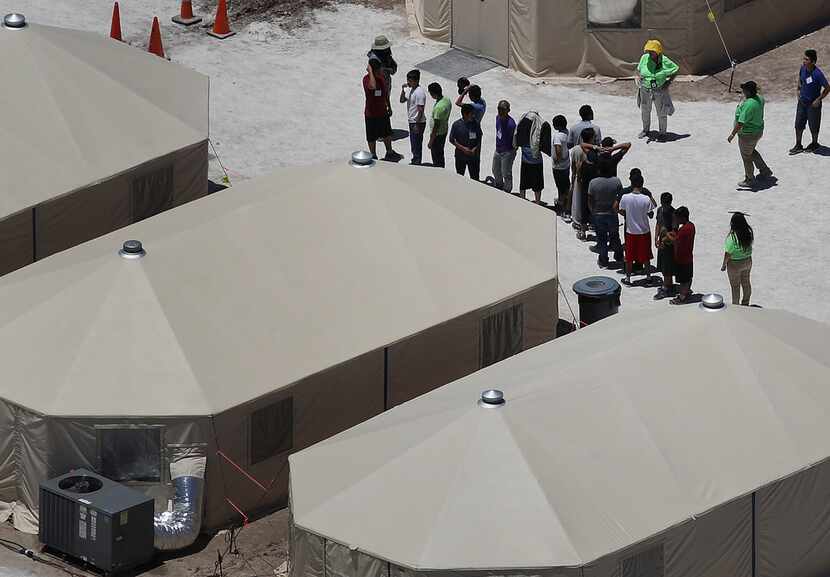 Children and workers are seen at a tent encampment recently built near the Tornillo Port of...