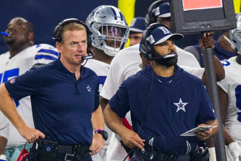 Dallas Cowboys head coach Jason Garrett and assistant coach Kris Richard stand on the...