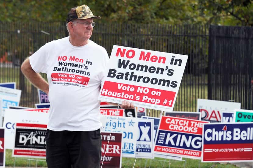  A demonstrator holds a sign against the Houston Equal Rights Ordinance outside an early...