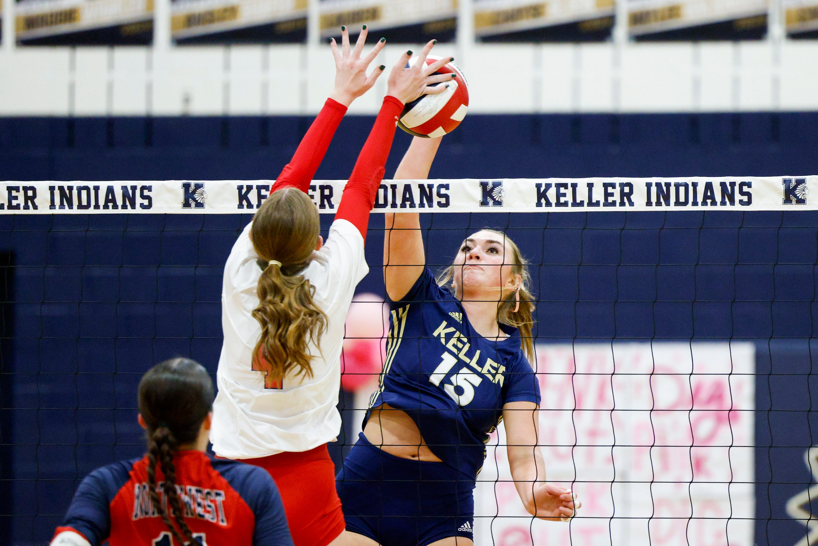 Justin Northwest's Payton Zondor (4) blocks a hit from Keller's Annabelle Nicher (15) during...