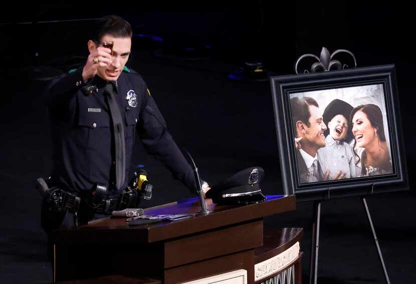 Dallas Police officer Colton Upchurch raises a shot glass of whiskey in his close friends...