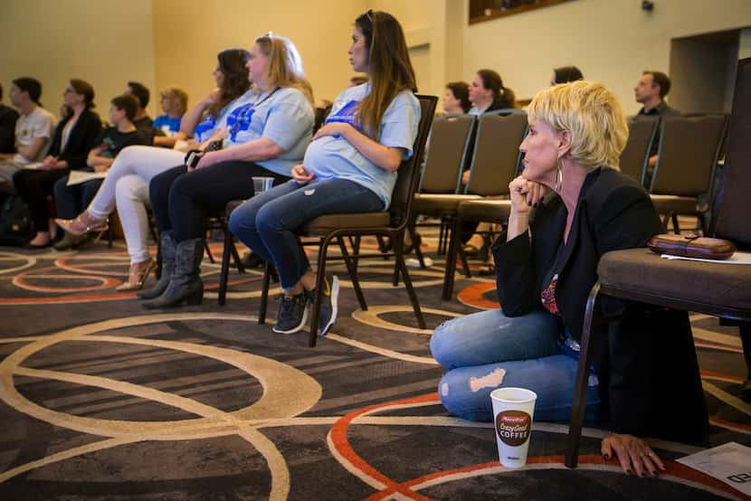 Environmental activist Erin Brockovich sits on the floor and listens as water consultant Bob...