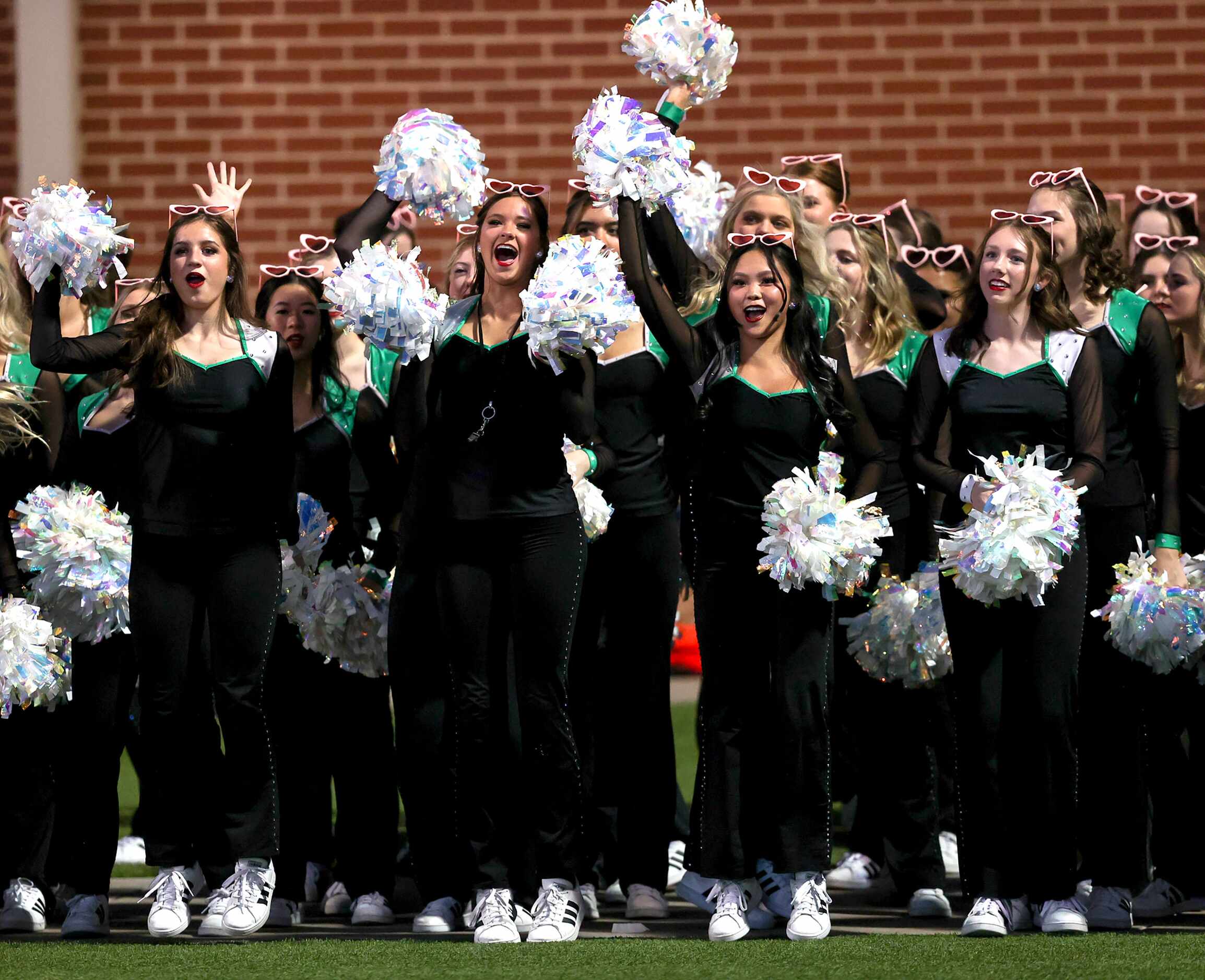 The Southlake Carroll cheerleaders cheer during the game against Eaton in a District 4-6A...