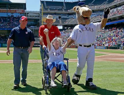Elizabeth Sullivan, 105-years-old from Fort Worth, on a wheelchair, waves to the crowd as...