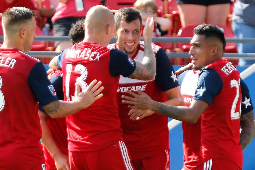 FC Dallas defender Matt Hedges (24) is congratulated by team mates after scoring the second...