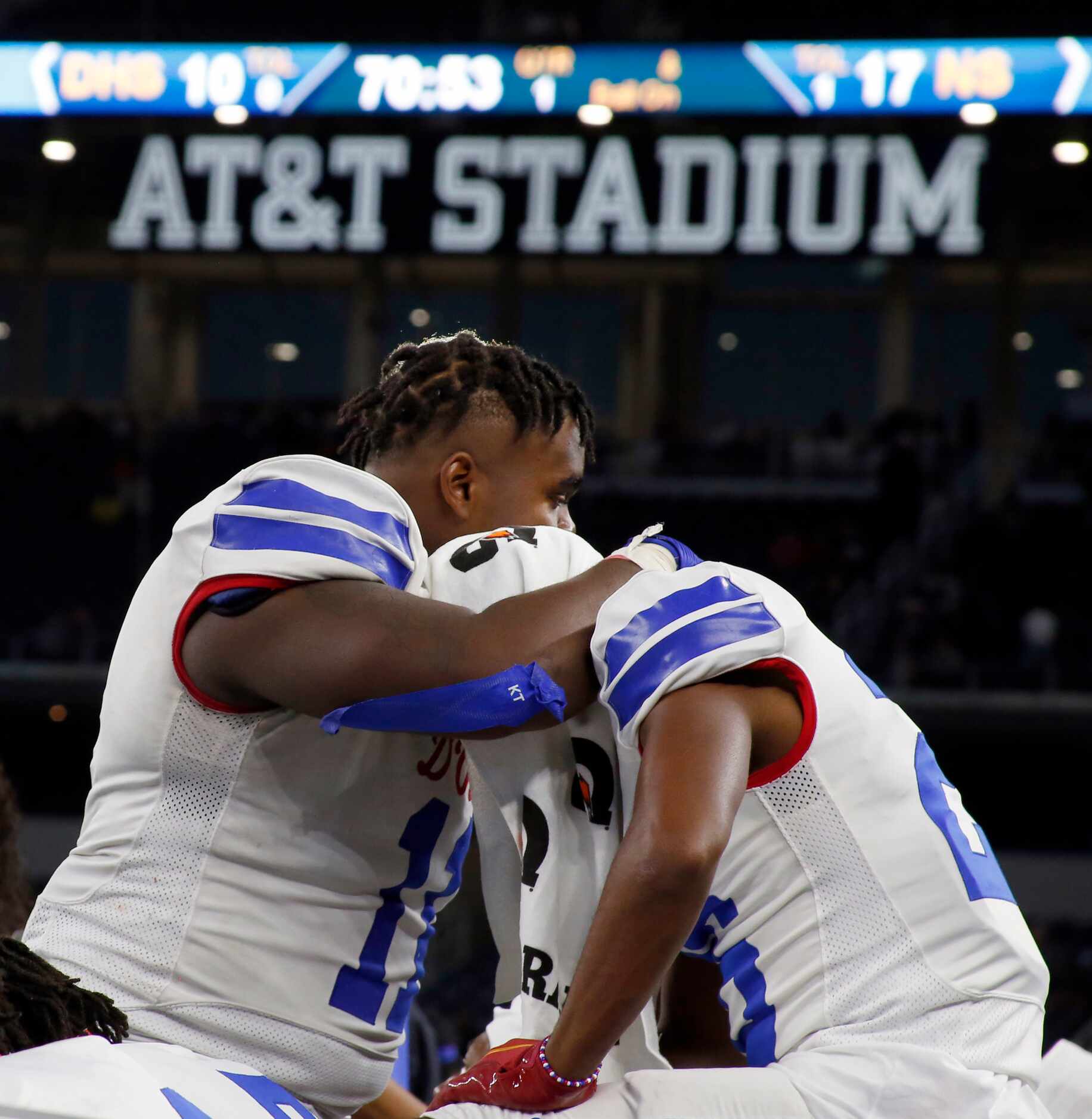 Duncanville defensive lineman Quincy Wright (11), left, consoles teammate Nick Thompson (26)...