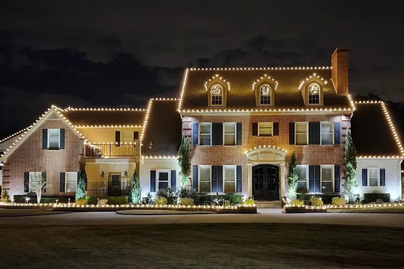 House lit up with holiday lights at night