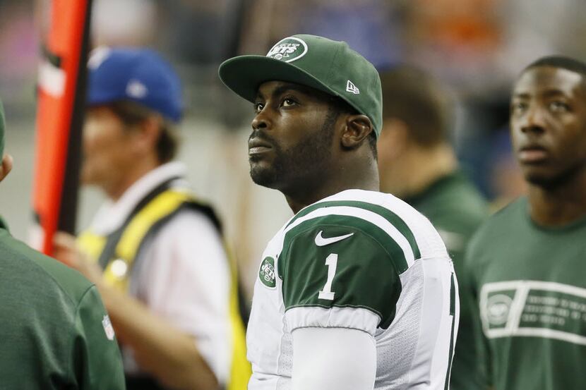FILE - IN this Nov. 24, 2014 file photo, New York Jets quarterback Michael Vick looks from...