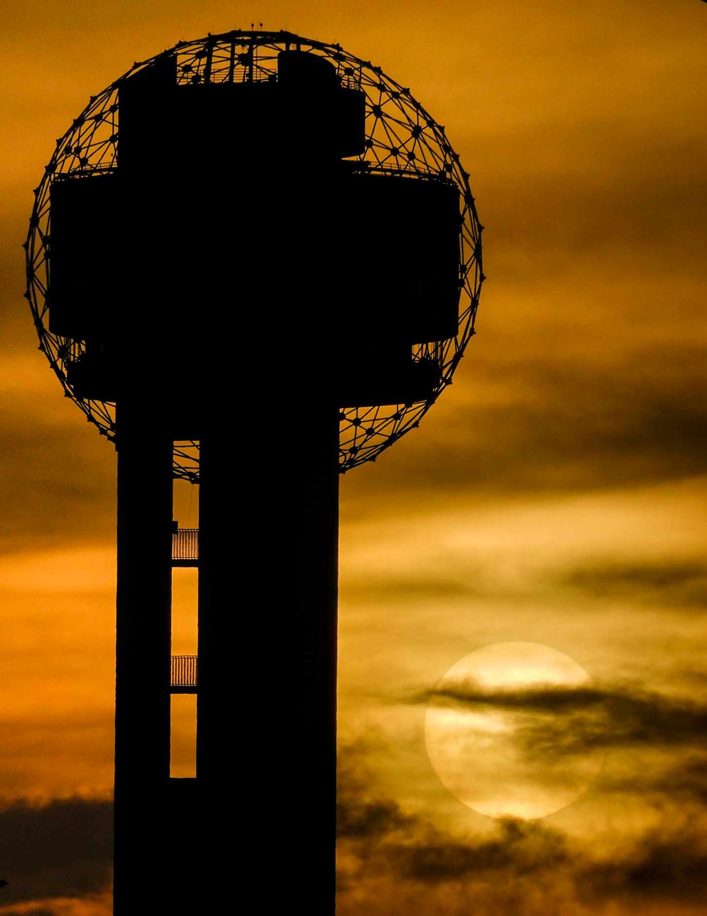 The sun sets behind Reunion Tower on Tuesday, June 30, 2020, in Dallas. Dissipating Saharan...