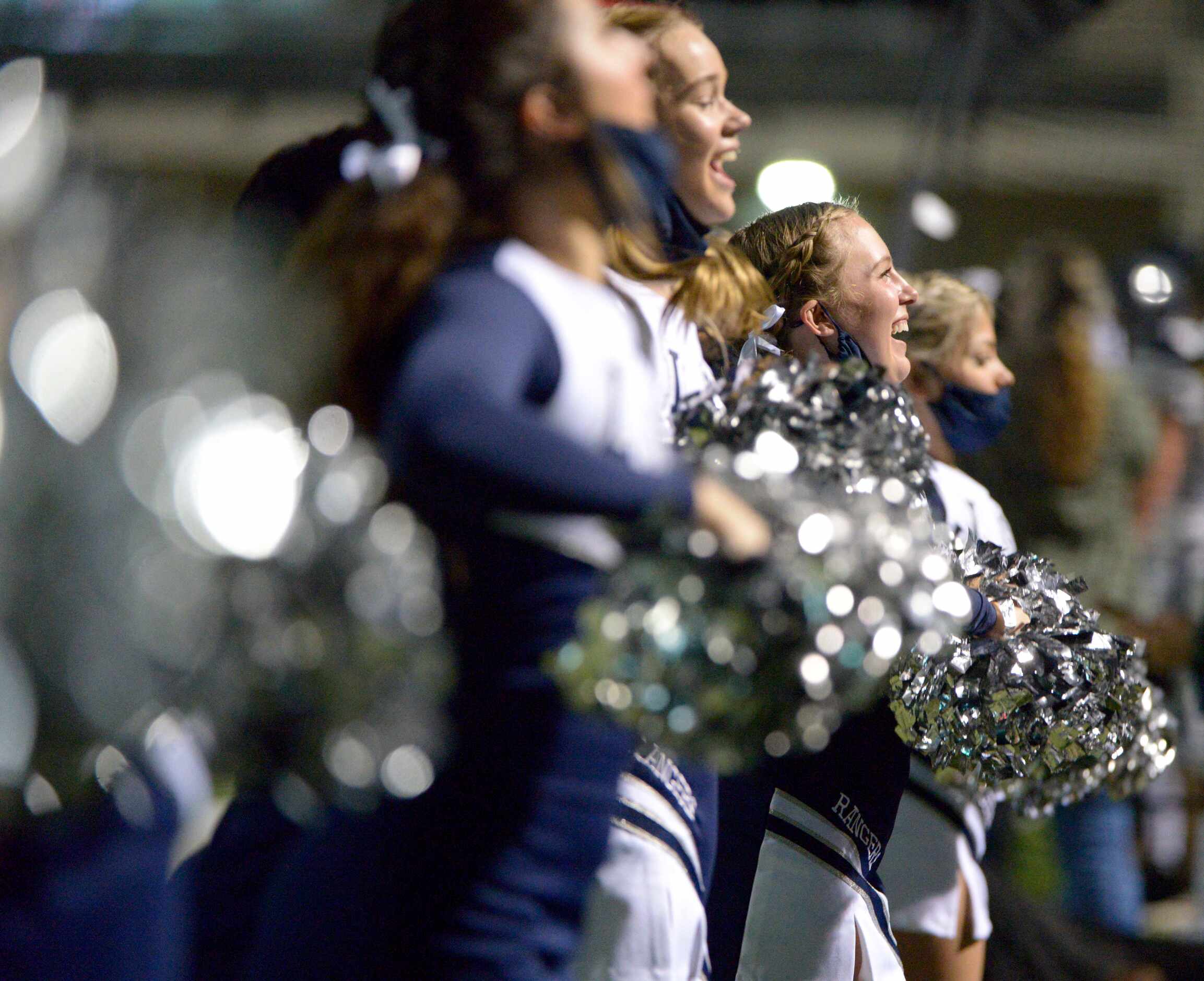 Lone Star cheerleaders perform in the second quarter of a high school football game between...