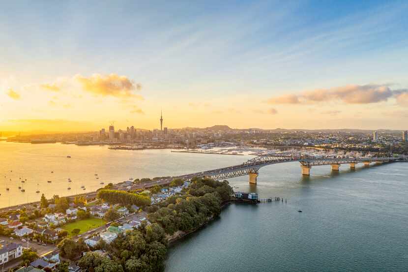 A panoramic image from above of Auckland, with the Sky Tower and CBD visible across...