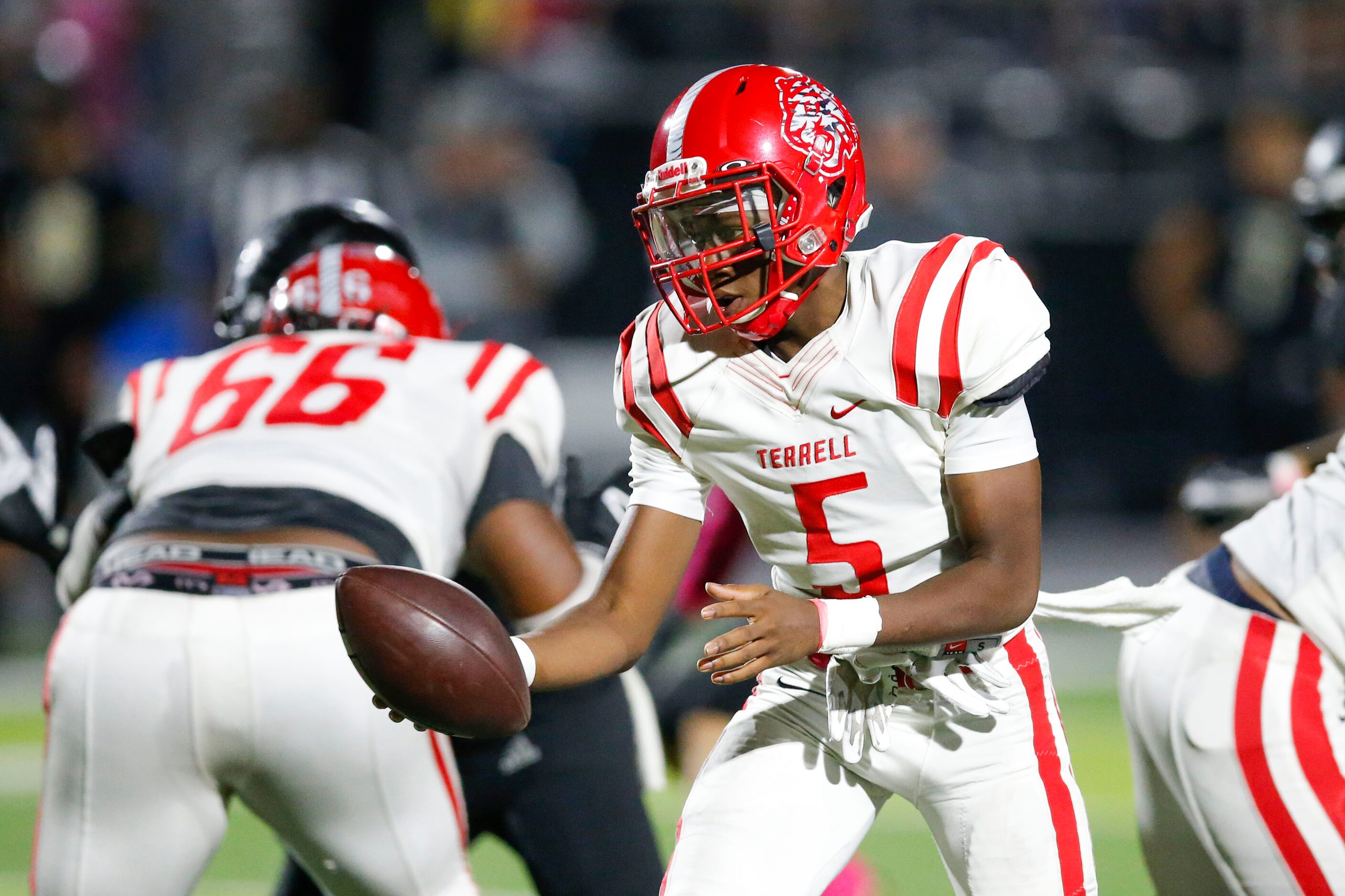 Terrell junior quarterback Montae Kennedy (5) looks to hand the ball off during the first...