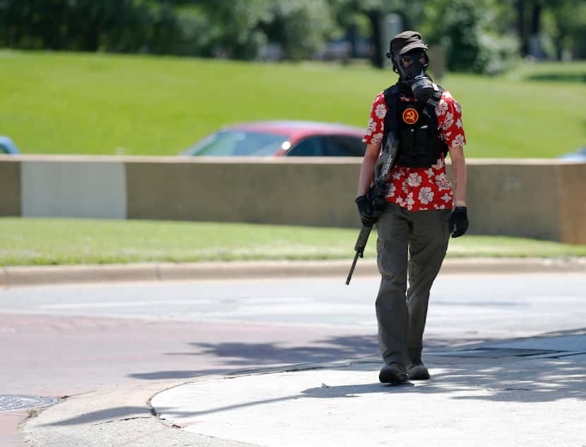 A person wearing a Hawaiian shirt and carrying a rifle appeared during a protest...