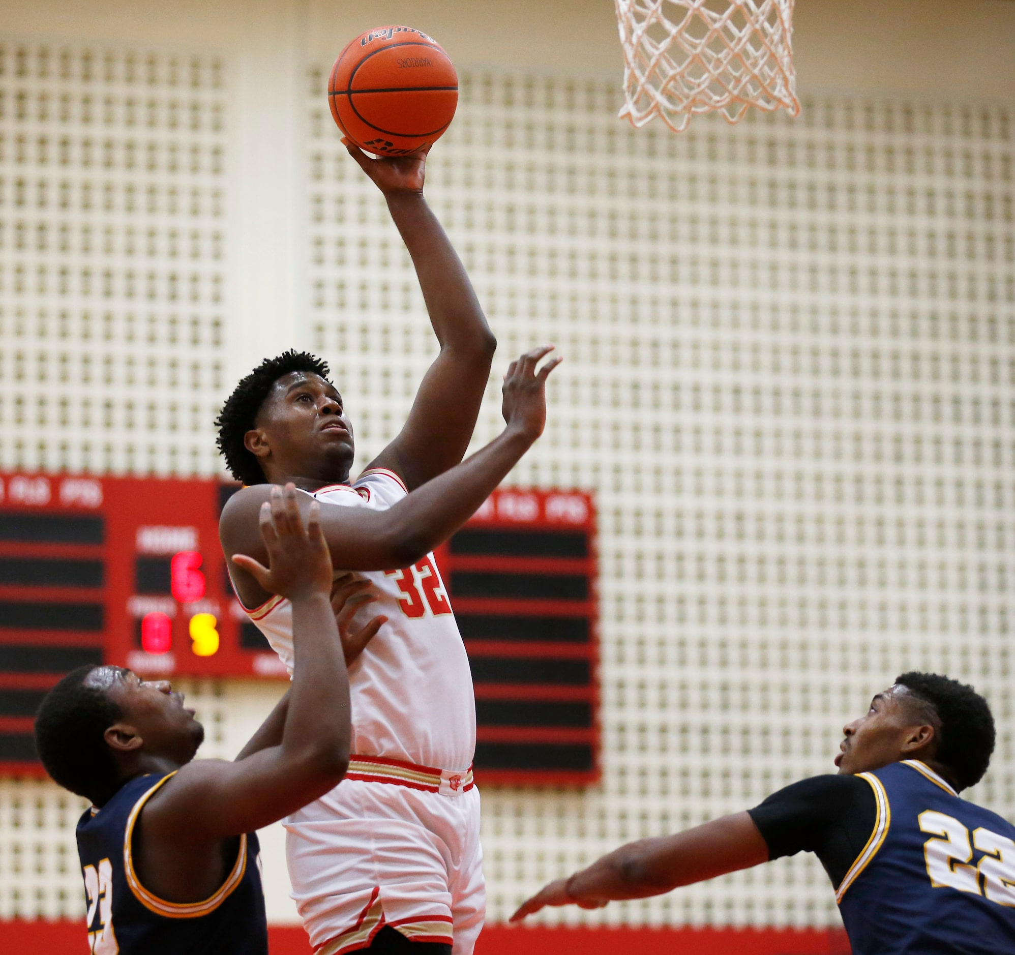 South Grand Prairie's Terin Johnson (32) attempts a shot in between Arlington Lamar's...