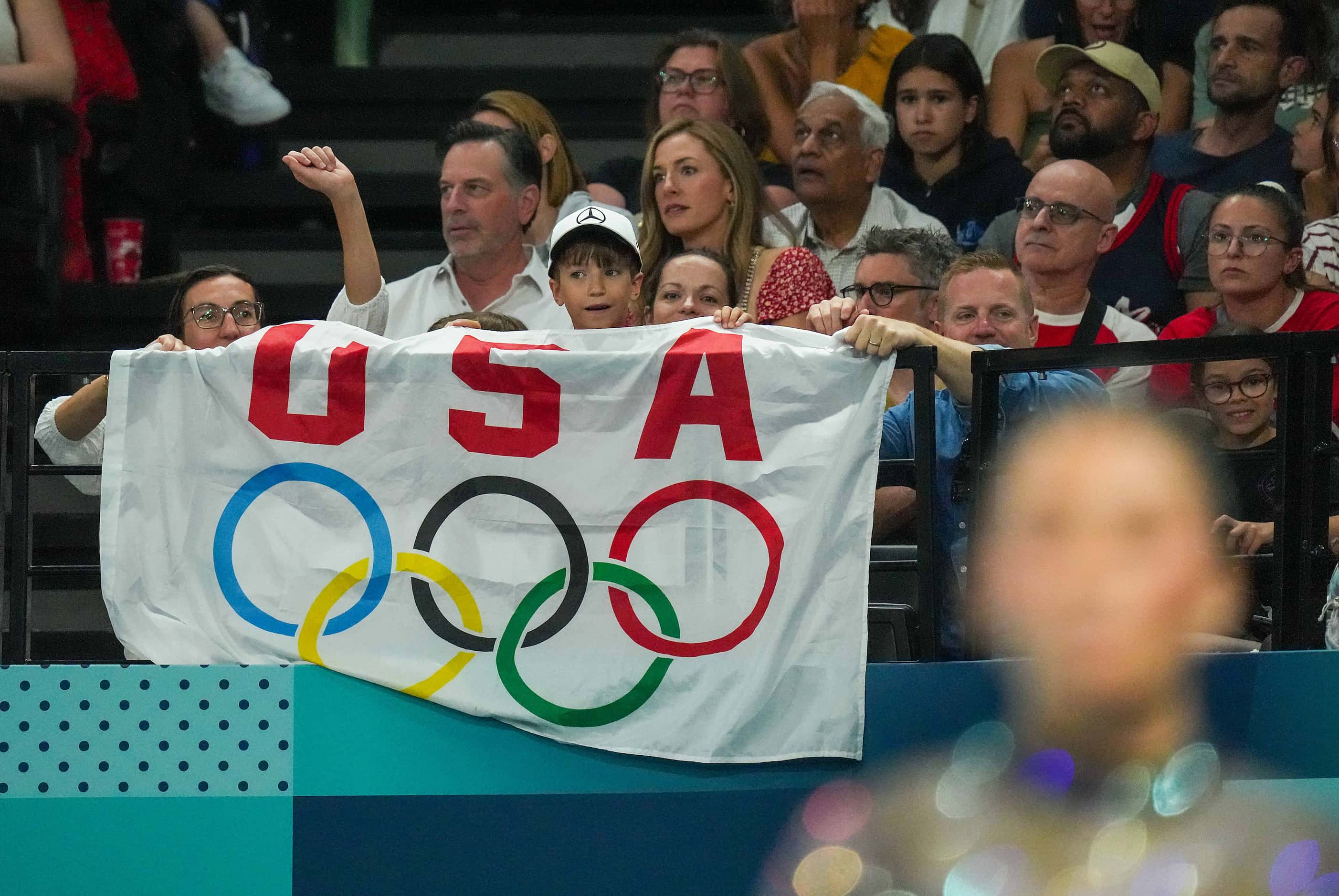 Fans cheer Suni Lee of the United States as she prepares to compete on the vault during...