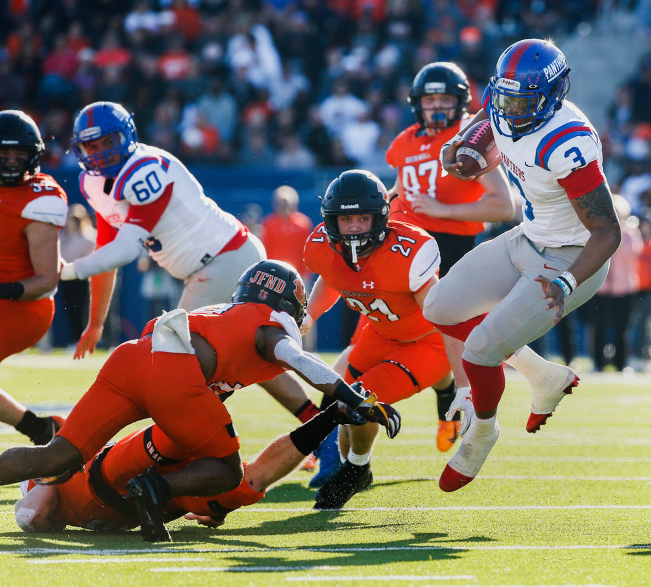 Duncanville quarterback Ja'Quinden Jackson (3) evades a swarm of Rockwall defenders during...