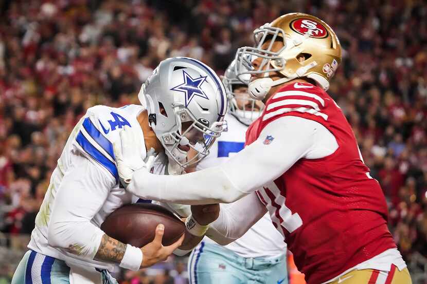Dallas Cowboys quarterback Dak Prescott (4) is nearly dropped for a safety in the end zone...