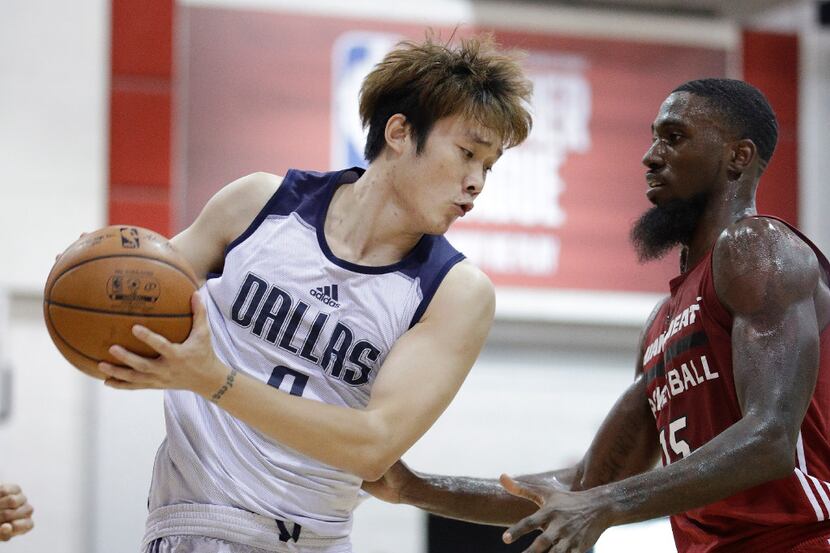 Dallas Mavericks' Ding Yanyuhang, left, of China, drives around Miami Heat's Okaro White...