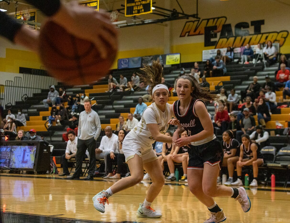 Plano East High School Kaitlyn Hong (10) and Coppell High School Allyssa Potter (4) watch...