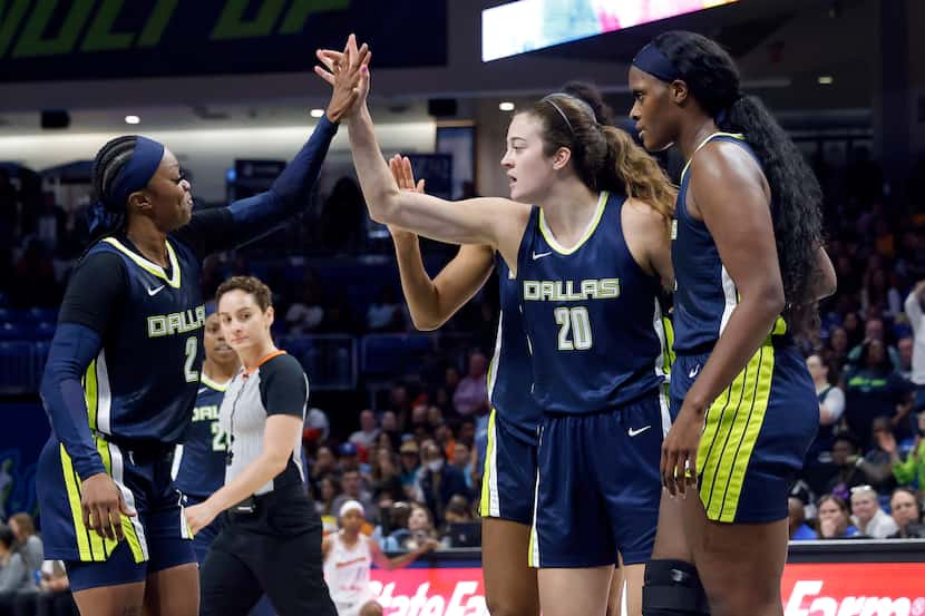Dallas Wings forward Maddy Siegrist (20) receives a high-five from teammate Odyssey Sims (2)...