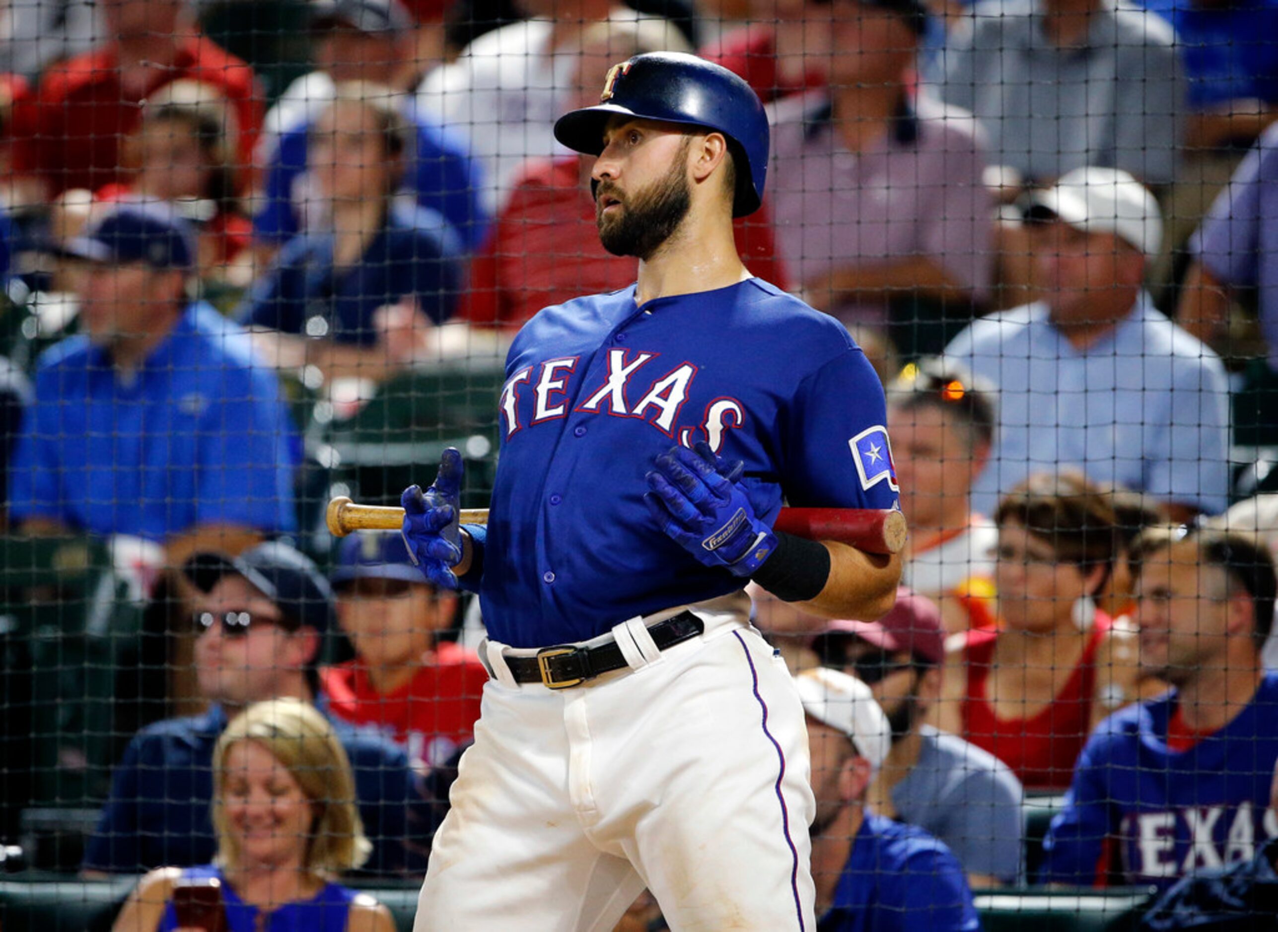 Texas Rangers batter Joey Gallo (13) stretches in the batting circle during the seventh...