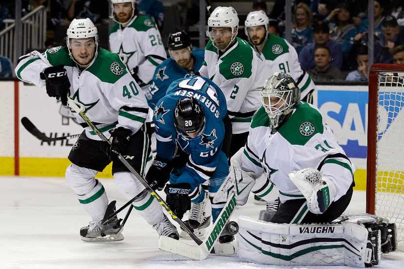 Dallas Stars goalie Antti Niemi, right, blocks a shot from the San Jose Sharks during the...