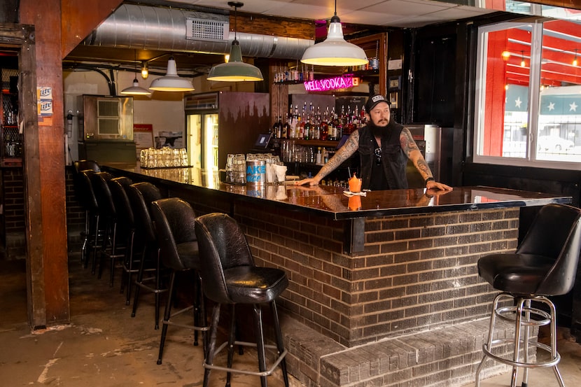 Co-owner Corey Howe stands behind the bar at Charlie’s Star Lounge.