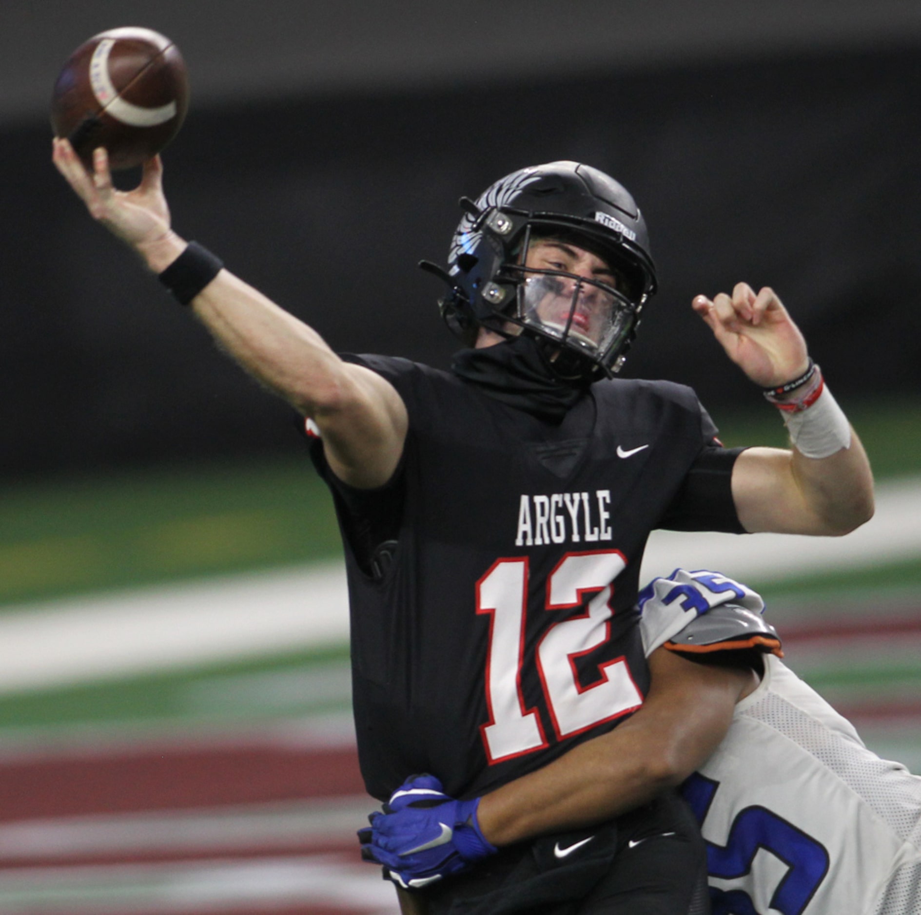 Argyle quarterback CJ Rogers (12) gets off a pass while under pressure by Lindale defensive...