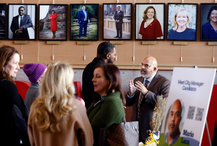 With photos of Dallas City Council members lining the wall, Sacramento Assistant City...