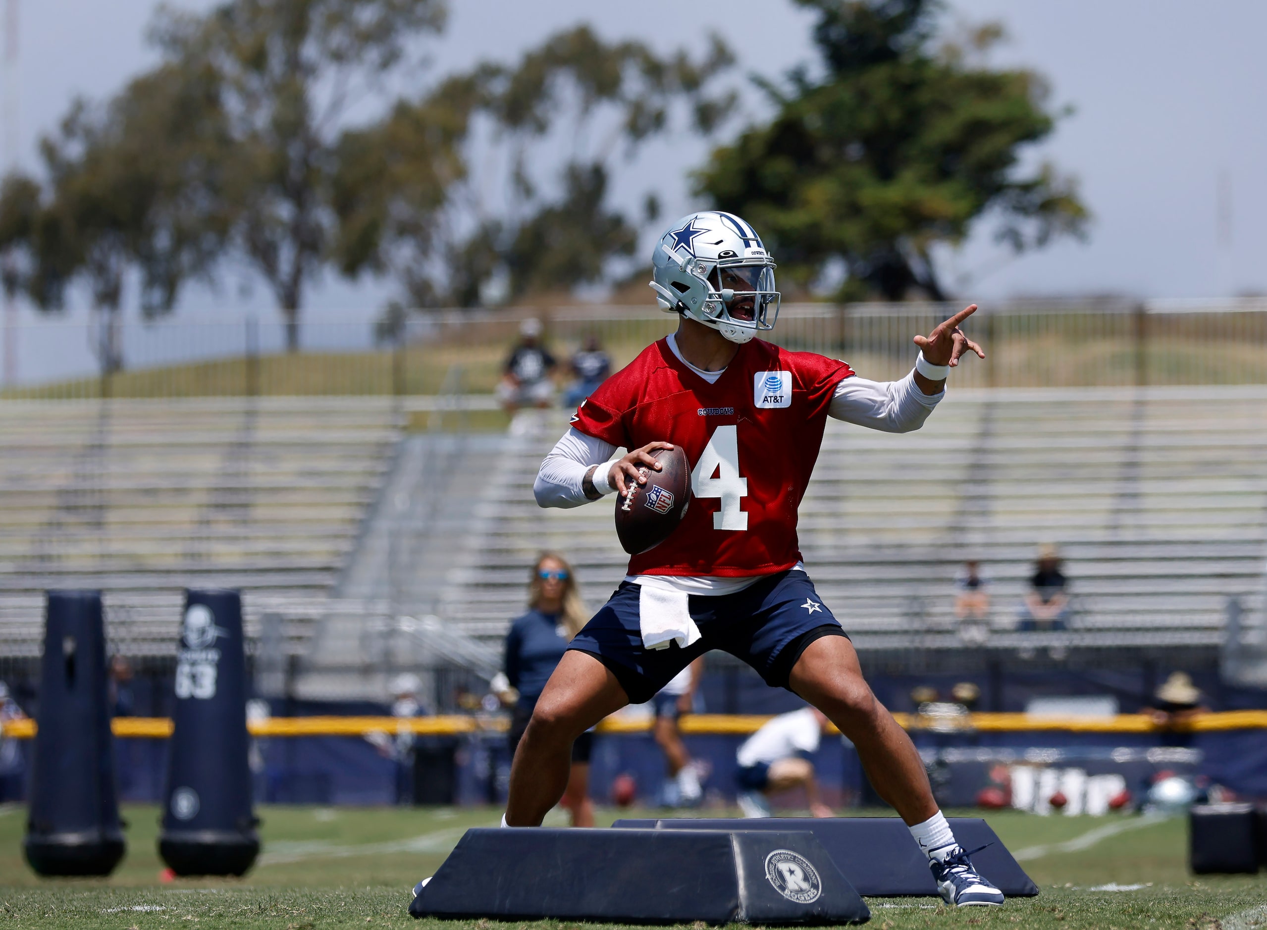 Dallas Cowboys quarterback Dak Prescott (4) points to his receiver as he negotiates the...