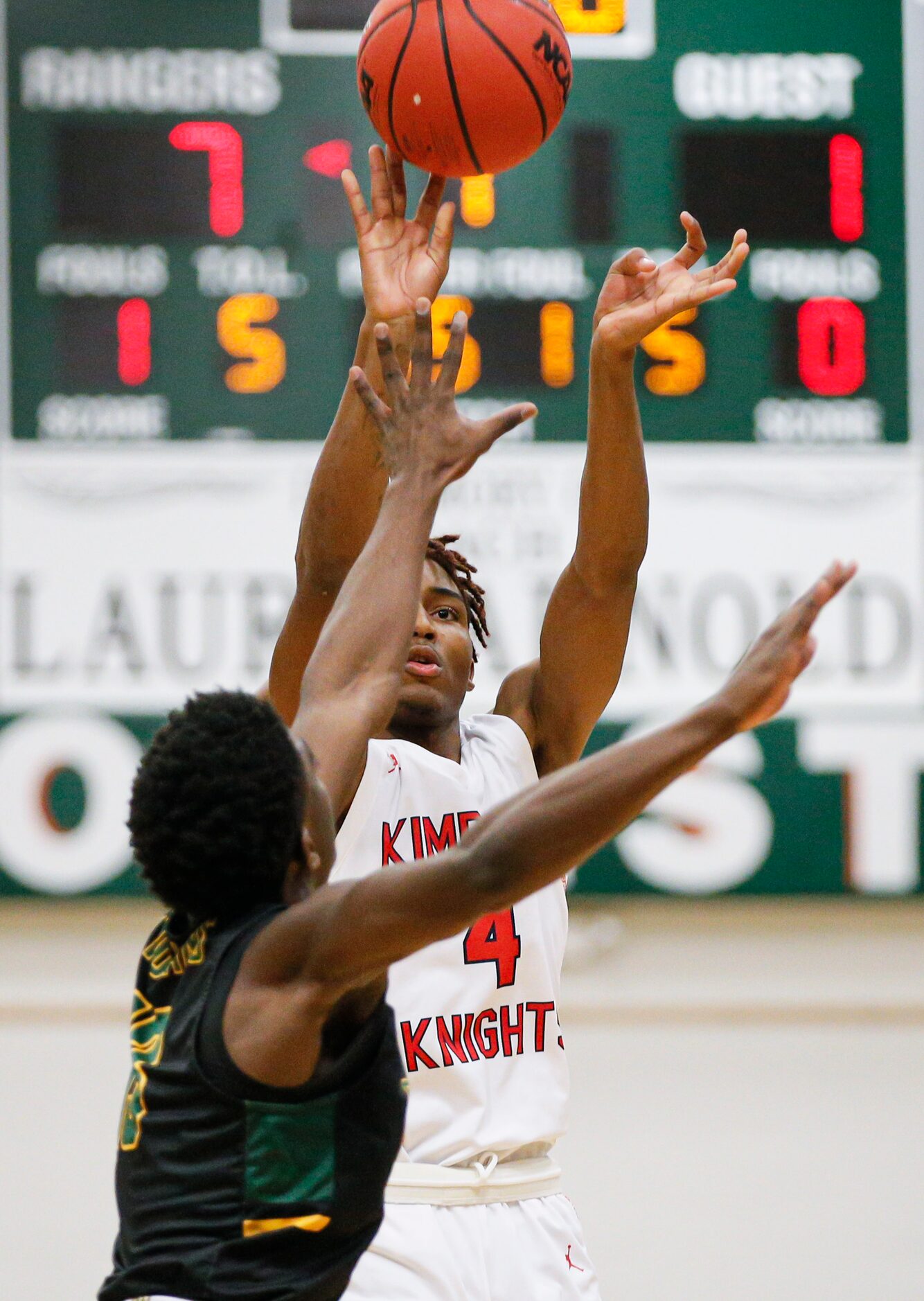 Kimball sophomore Arterio Morris attempts a shot as Newman Smith senior Bobby Smith III...