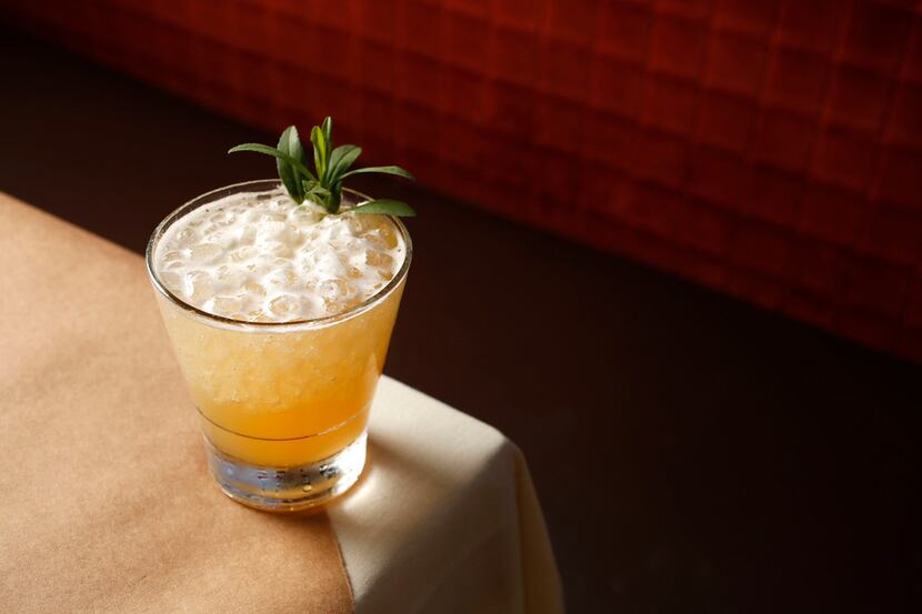 The All Hopped Up cocktail with bourbon, grand poppy liqueur, lemon, hopped syrup and...